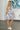 Full body view of female model wearing the Payton Blue & Peach Floral Mini Dress which features Blue, Peach, Tan and Periwinkle Lightweight Fabric, Floral Pattern, Flare Hem Skirt, Mini Length, Scoop Neckline and Adjustable Straps