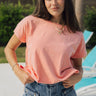 Front view of female model wearing the Jane Peach Short Sleeve Top which features  Peach Cotton Fabric, Slits on each side, Short Sleeves and Round Neckline
