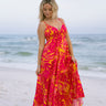 Full body front view of female model wearing the Melina Orange & Pink Floral Maxi Dress that has bright orange and pink floral pattern, adjustable straps, and an open back.