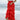Lower body side view of female model wearing the Katrina Tiered Ruffle Maxi Skirt in Red that has tiered red fabric and an elastic waist. Worn with white top tucked in.