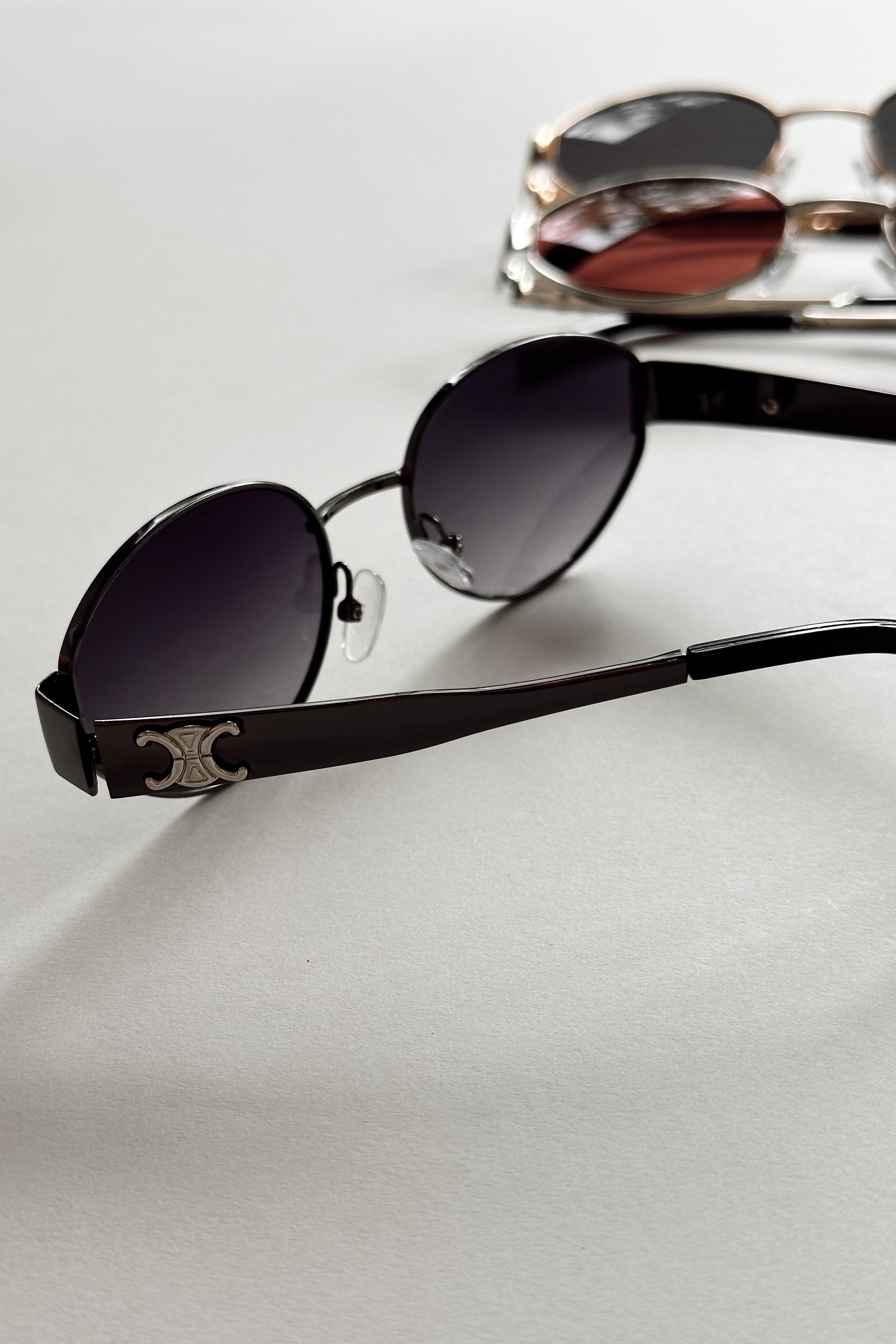 Clarissa Sunglasses in Black - flat lay - side view
