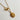 Close-up image of the Alexandra Gold Medallion Necklace against a white background. Necklace has gold chain with toggle closure and gold circle medallion with side profile of a gladiator.