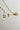 Image of the Alexandra Gold Medallion Necklace against a white background. Necklace has gold chain with toggle closure and gold circle medallion with side profile of a gladiator. Necklae is shown unhooked.