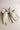 Flat lay view of Felicity Hair Bow Barrette in Ivory/Black which features ivory fabric with black fabric trim, double bow with a french barrette clip