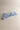 Flat lay view of the Amelia Sheer Hair Bow Barrette in Light Blue which features light blue sheer fabric, light blue satin trim, double bow with a french barrette clip.