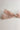 Close up view of the Amelia Sheer Hair Bow Barrette in Light Pink which features light pink sheer fabric, light pink satin trim, double bow with a french barrette clip.
