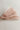 Close up view of the Amelia Sheer Hair Bow Barrette in Light Pink which features light pink sheer fabric, light pink satin trim, double bow with a french barrette clip.