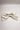 Image shows back of the Stacia Embellished Velvet Hair Bow in Ivory against a white background that features ivory velvet fabric with gold dot embellishments and a clasp closure.