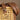 Lola Brown & Gold Faux Leather Belt - front view of belt on chair