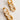 Flat lay detailed view the Lyla Neutral Tortoise Chain Link Earring which features tan and white tortoise chain links together.