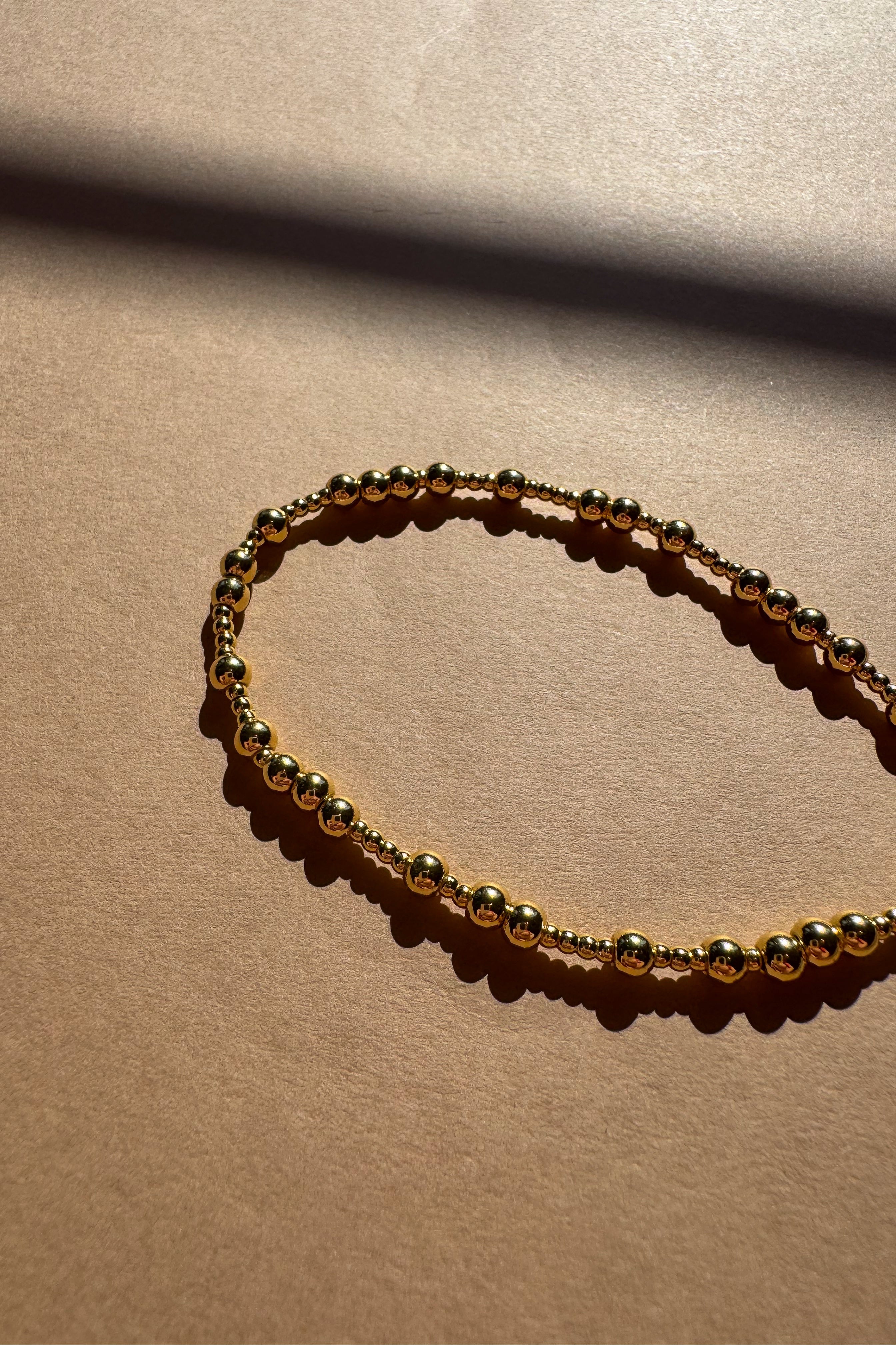 Liana Gold Beaded Bracelet - close up flat lay
