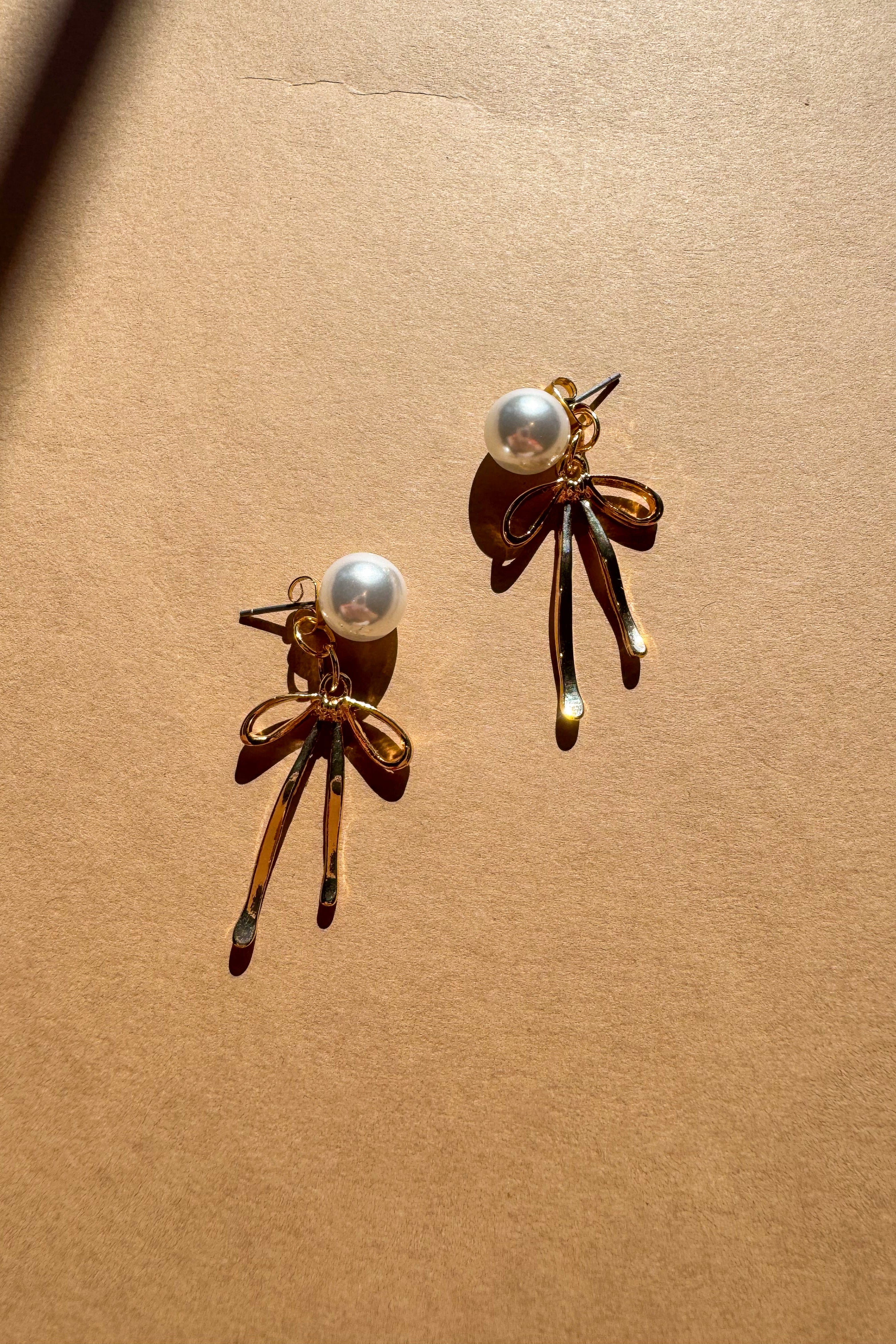Vanessa Gold Bow & Pearl Earrings - flat lay top view