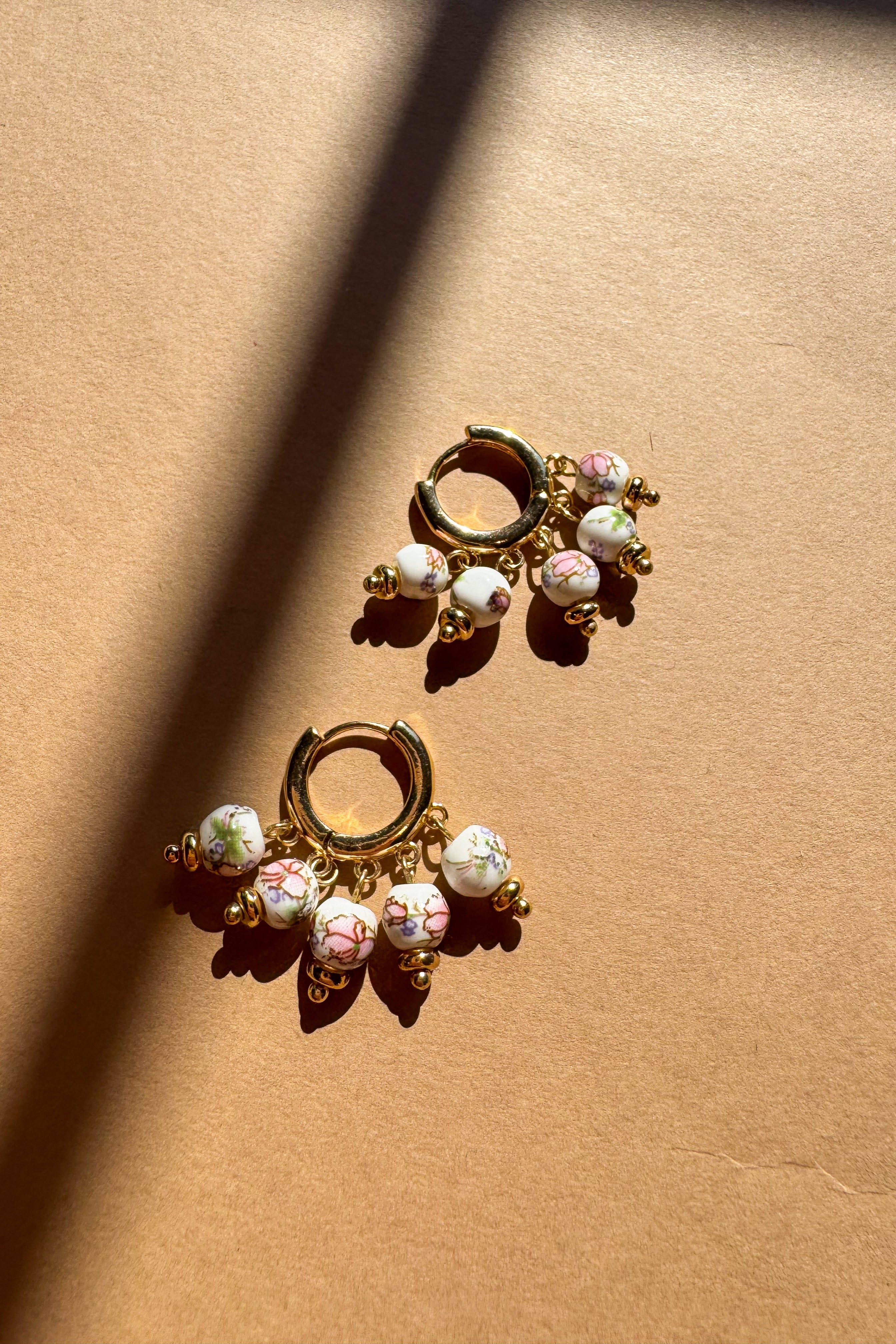 Hailey Floral Beaded Huggie Earrings - flat lay top view