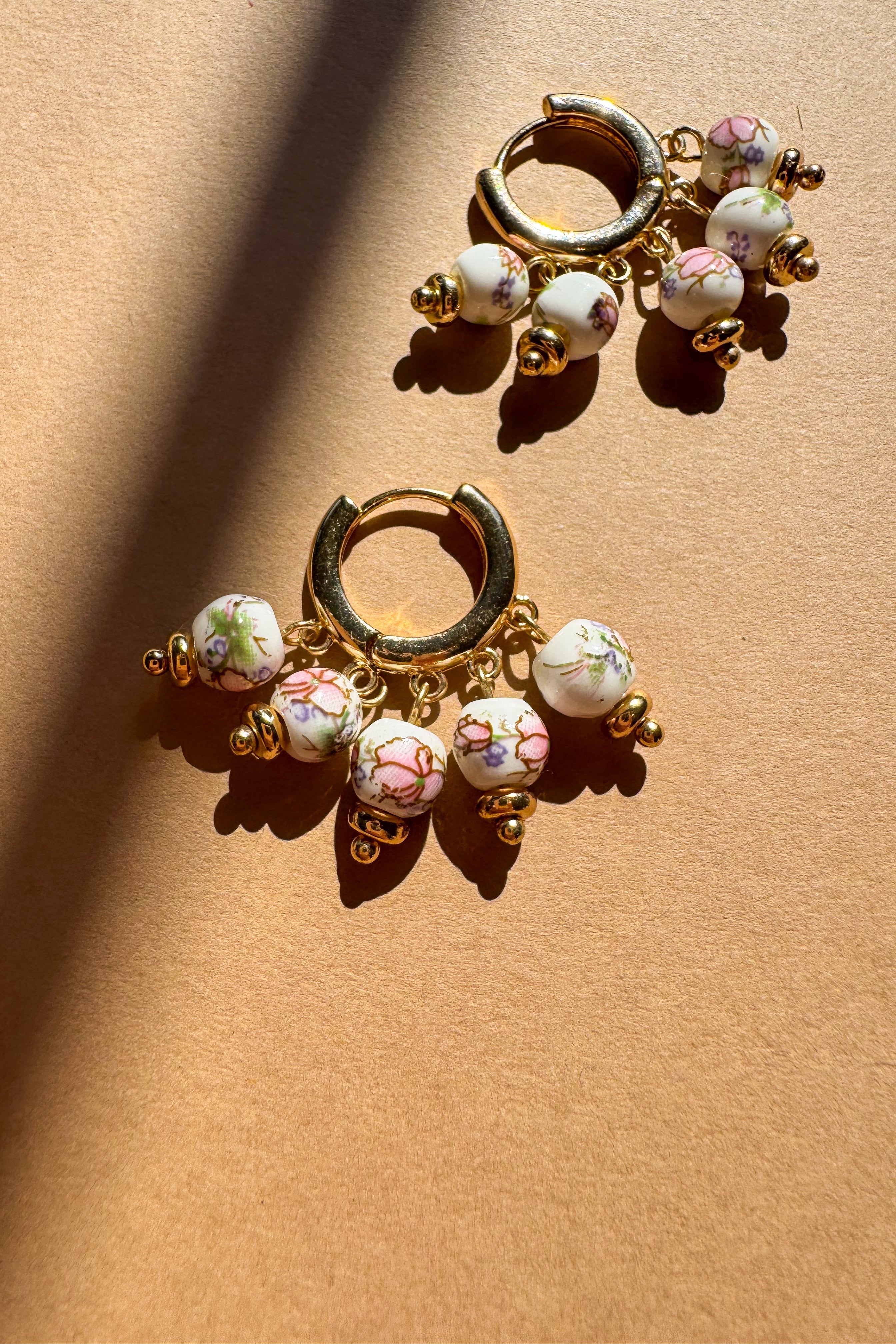 Hailey Floral Beaded Huggie Earrings - flat lay close up