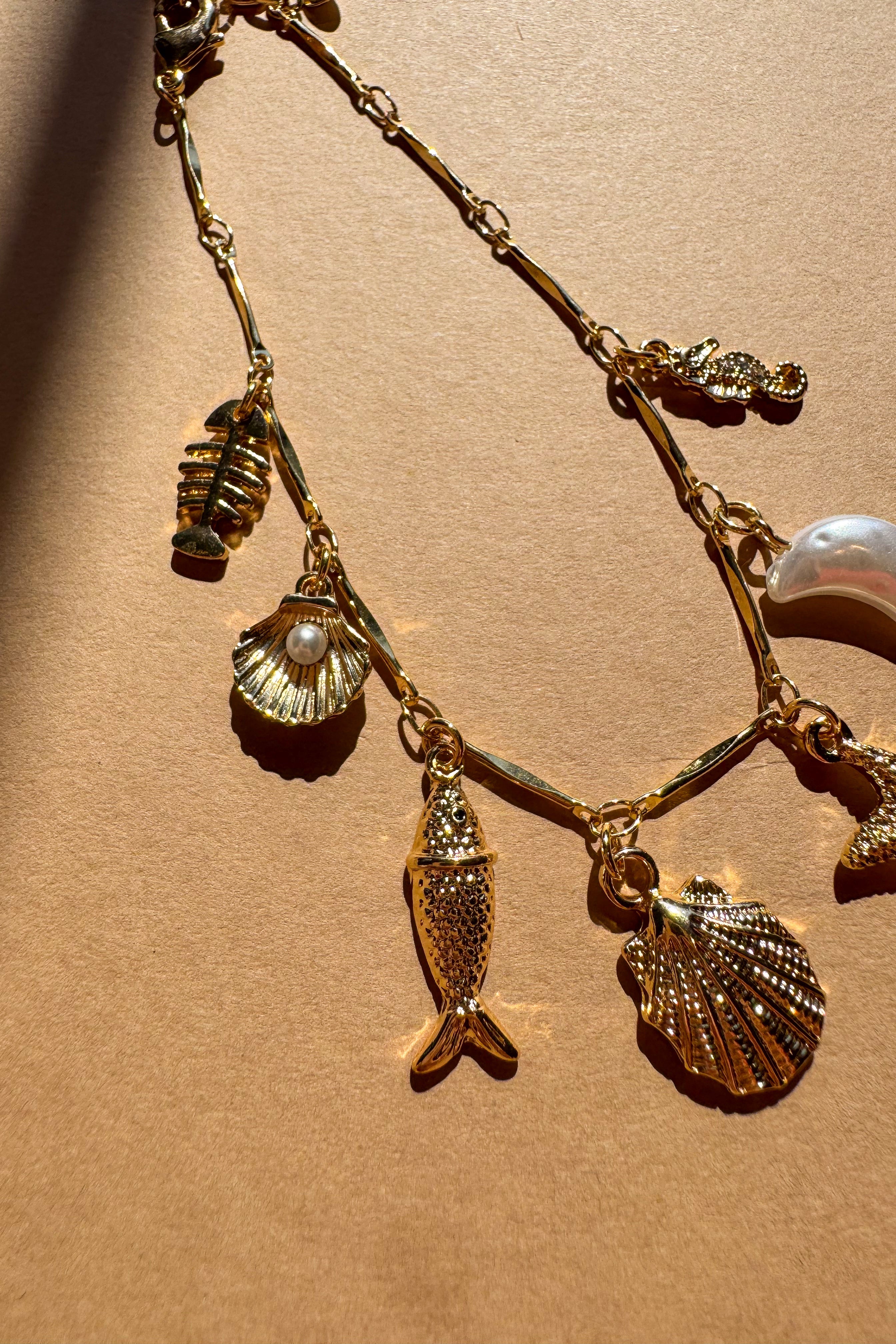 Genevieve Gold Coastal Charm Bracelet - close up of flat lay
