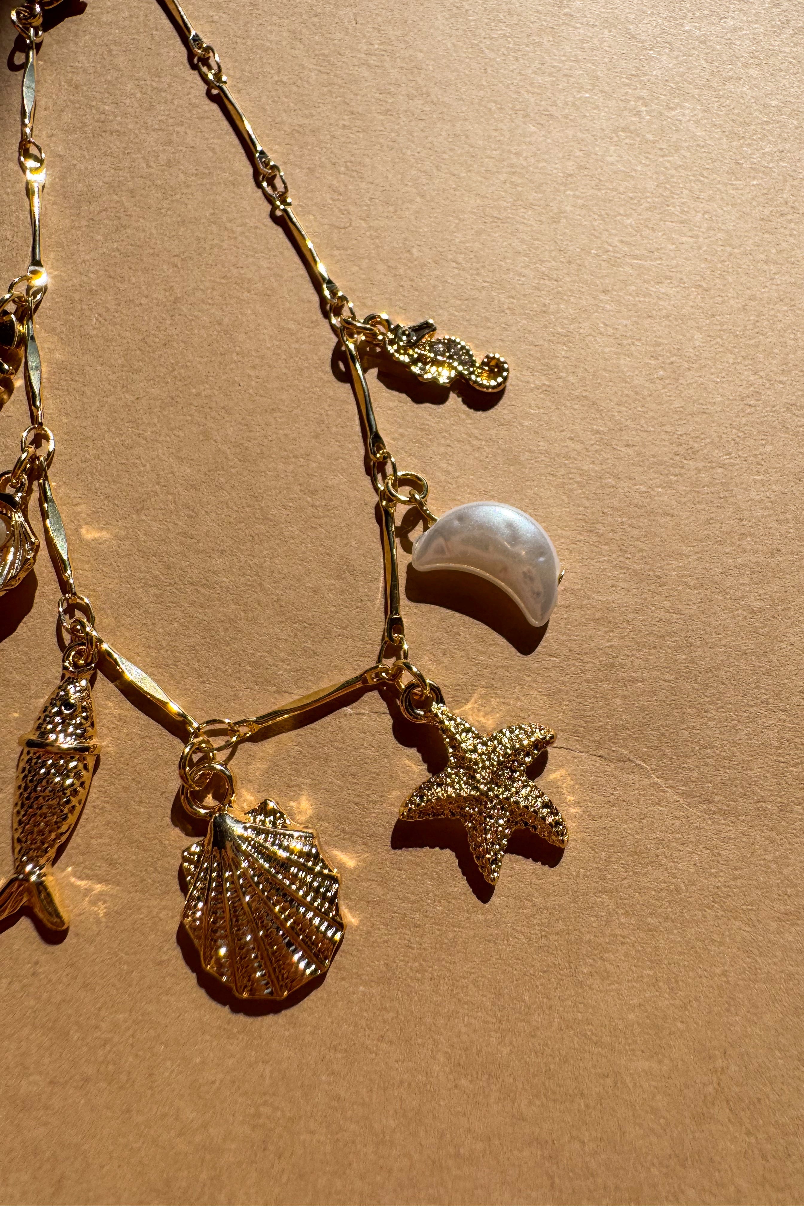 Genevieve Gold Coastal Charm Bracelet - flat lay close up