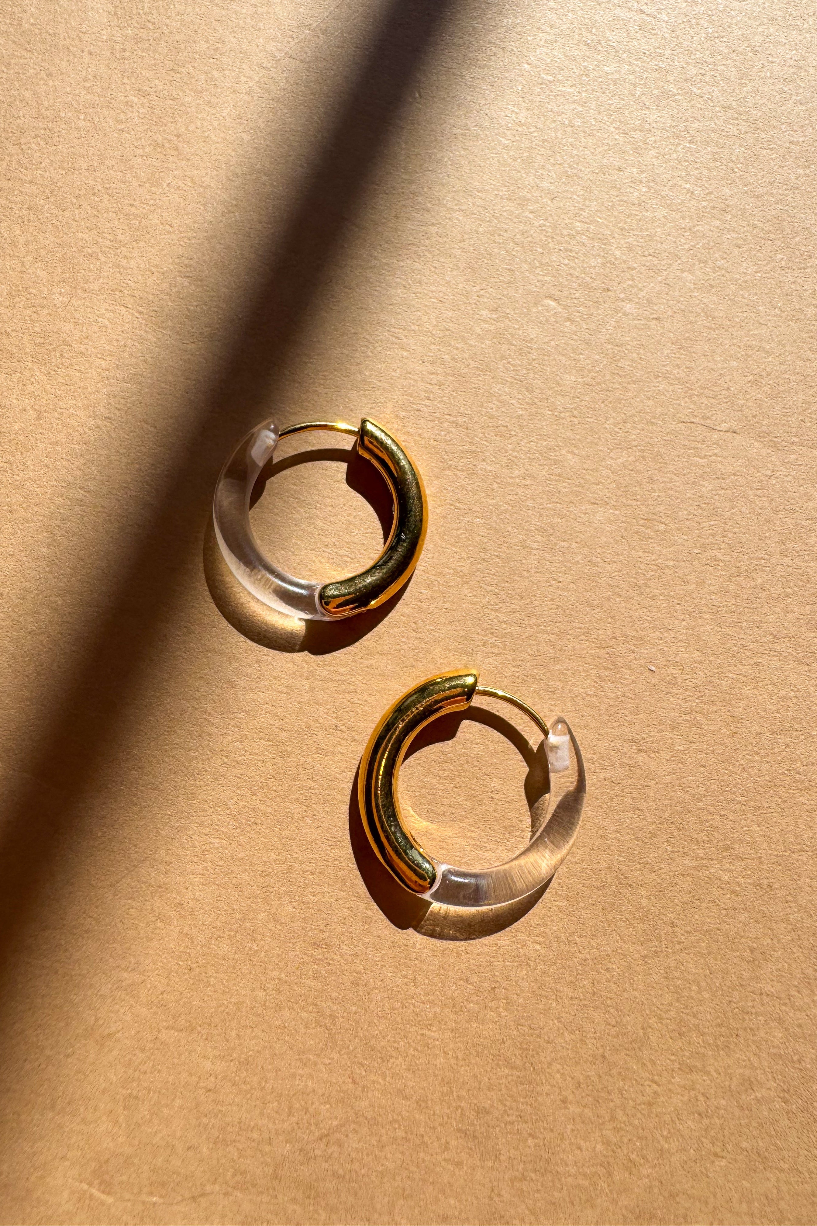 Kara Clear & Gold Dipped Hoop Earrings - flat lay top view