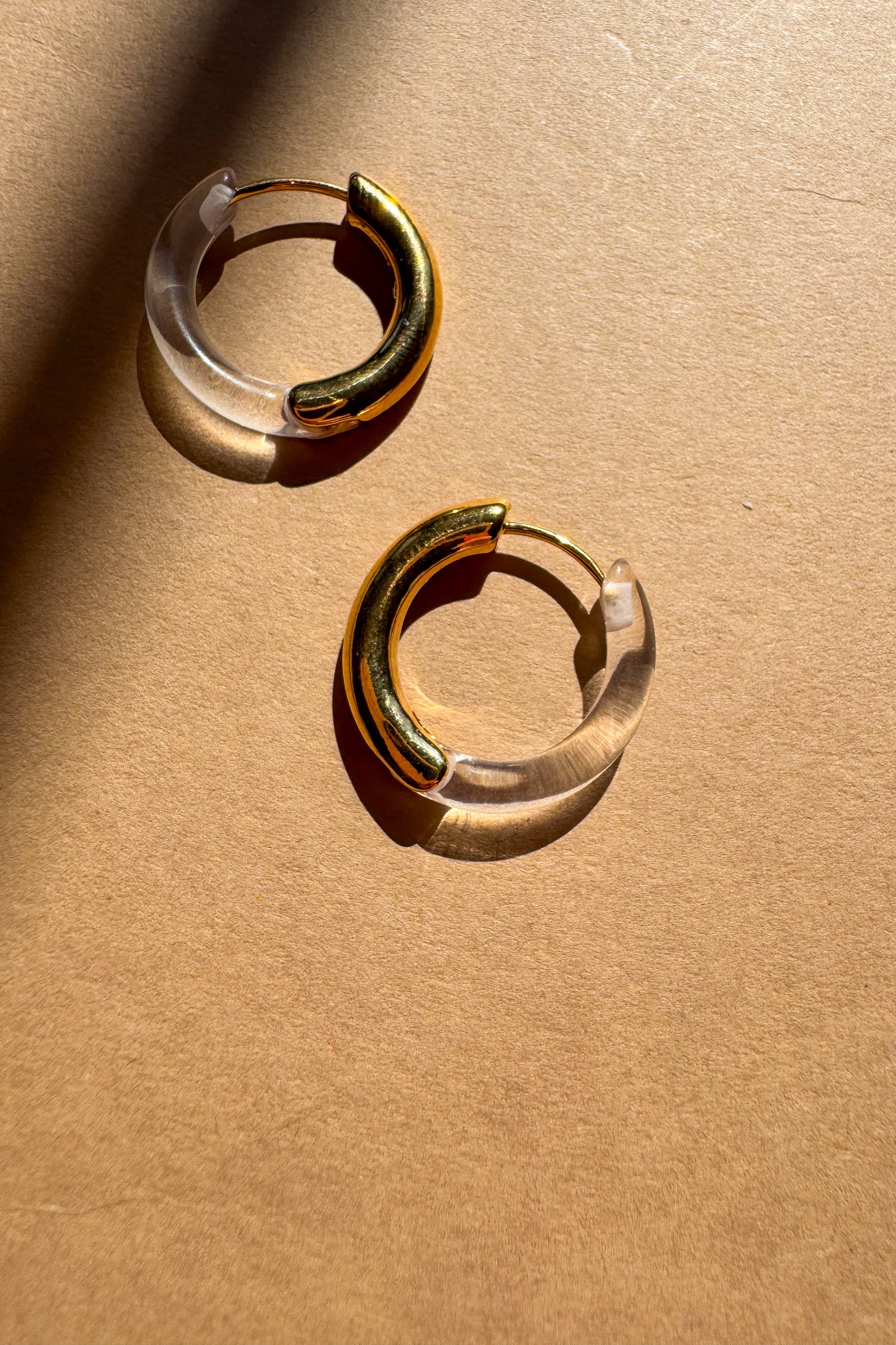 Kara Clear & Gold Dipped Hoop Earrings - flat lay close up