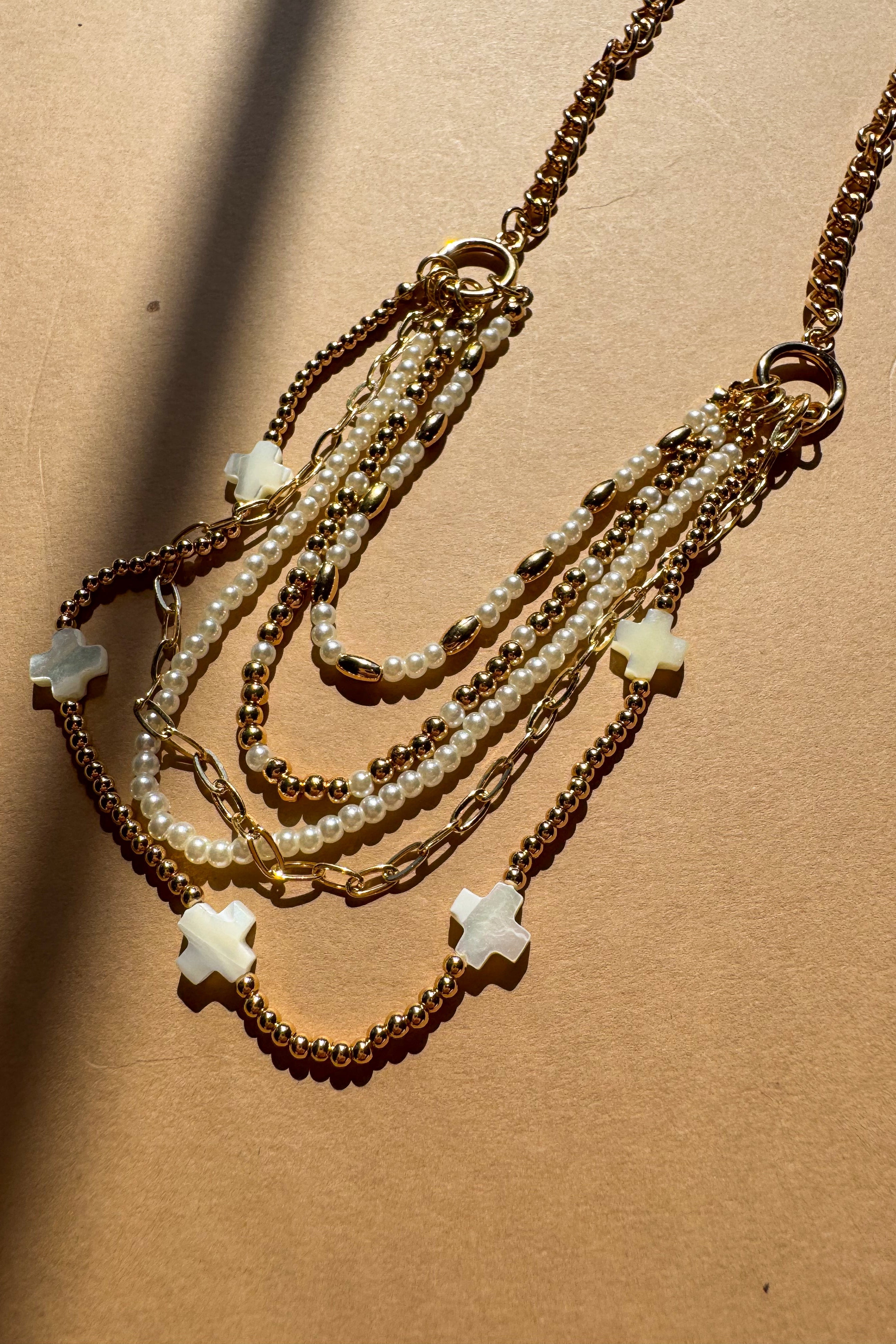 Nyla Gold & Pearl Layered Cross Necklace - flat lay top view