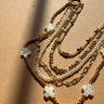 Nyla Gold & Pearl Layered Cross Necklace - close up flat lay