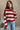 Delaney Red & Gold Striped Sweater-front view with model's hand on chest