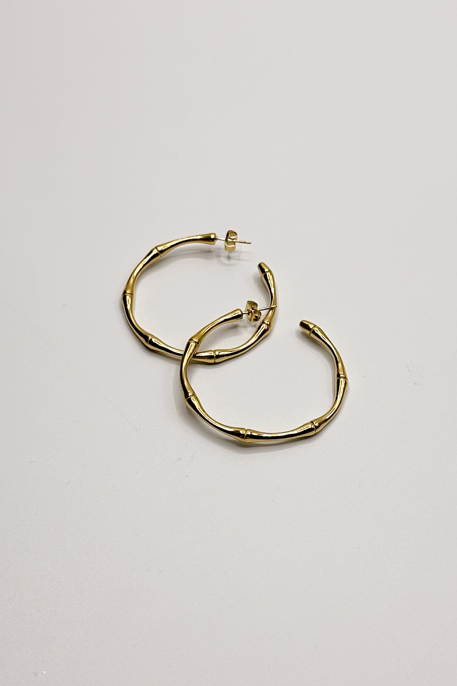 Lola Gold Bamboo Hoop Earring- flat lay view