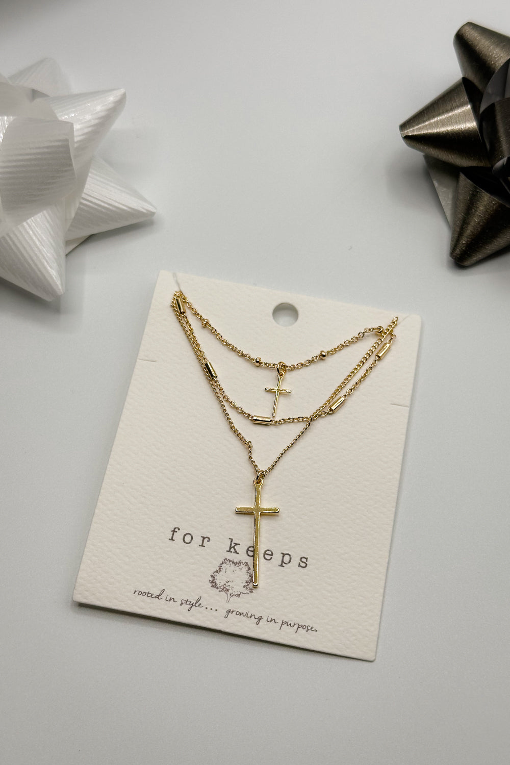 Livia Triple Layer Gold Cross Necklace- close up flat lay view