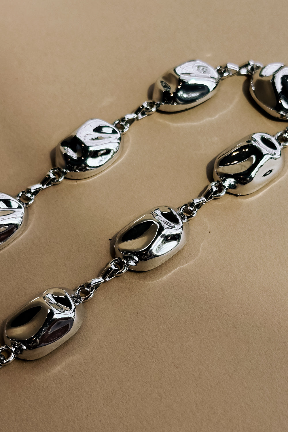 Aurelia Silver Hammered Chain Link Belt- close up flat lay view