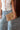 Tessa Natural Woven Collapsible Purse - held by model