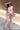 The Gianna Cream & Orange Floral Pants - front view on model