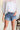 Just USA: Celine Medium Wash Distressed Denim Shorts- front view