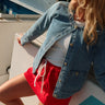 Jane Medium Wash Denim Jacket - close front view with red skirt