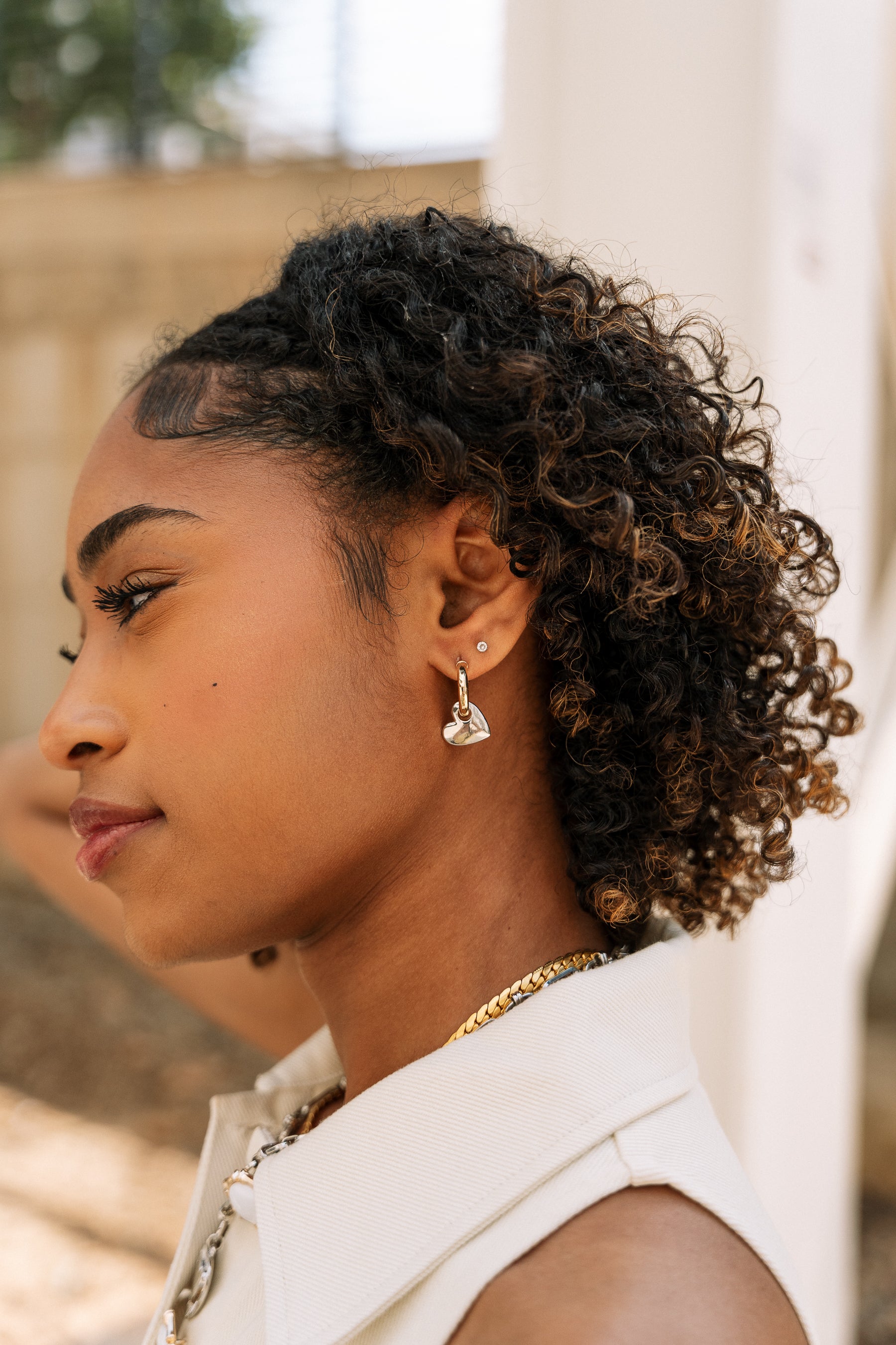 Laurel Gold & Silver Heart Huggie Earring- close up side view