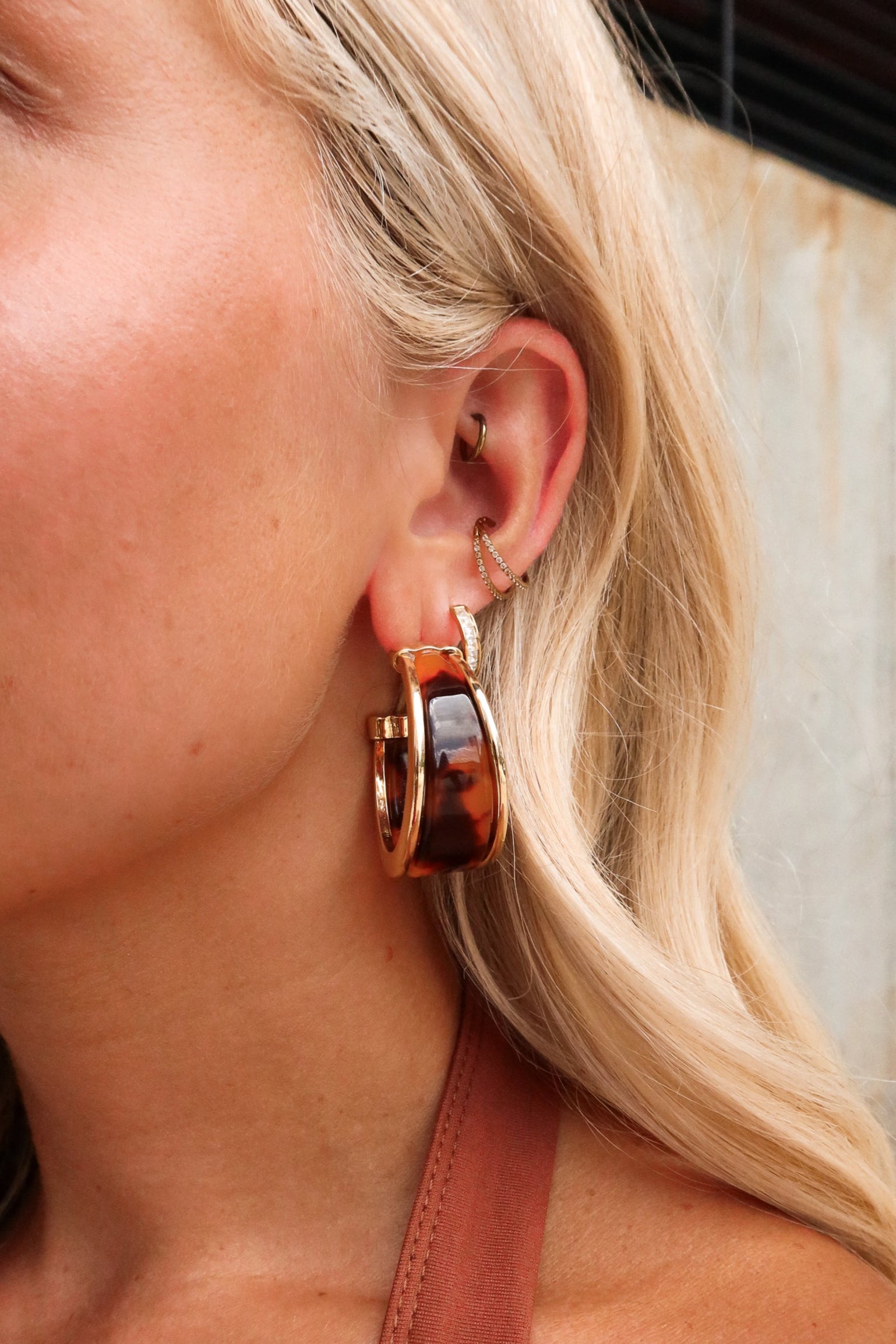 Helena Tortoise Hoop Earrings -close close up of earrings on model