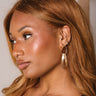Regina Gold Ribbed Dangle Earrings - side view on model