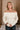 Raya Ivory Fringe Off-The-Shoulder Sweater- top view