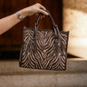 Dinsdale Chocolate Brown & Cream Zebra Purse- front view being held