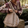 Angela Taupe Suede & Studs Tote - side view on model