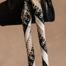 Lyla Navy Multi Printed Satin Scarf - close up tied on purse