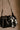 Willow Black Faux Leather Drawstring Purse - close front view with scarf accent
