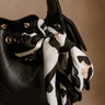 Harlow Leopard Print Satin Scarf - close up tied to purse
