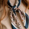 Chandler Navy Multi Tropical Print Satin Scarf - close up front view tied on model's neck