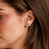 Simone Gold & Pearl Cross Stud Earrings - side view on model