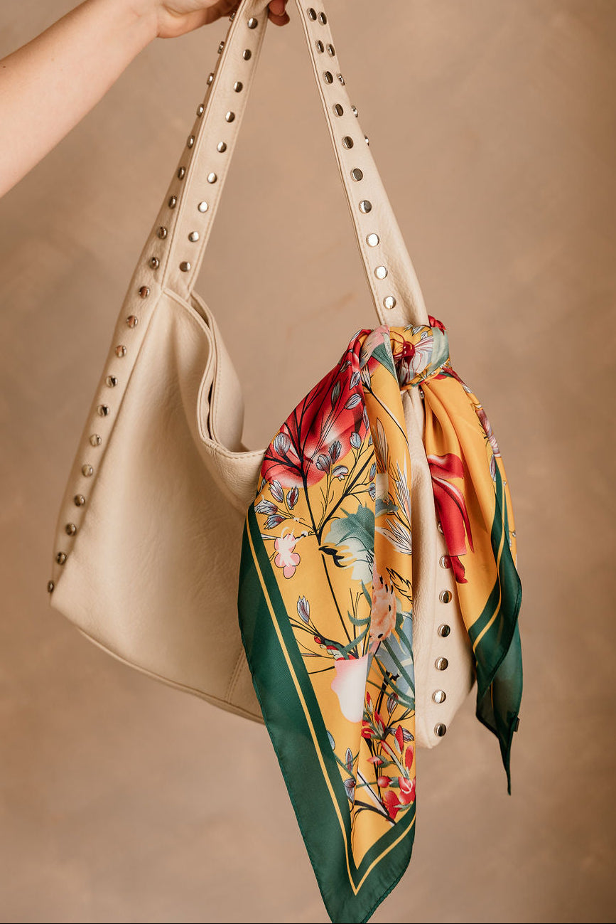 Carmella Mustard Multi Floral Satin Scarf - shown tied on purse