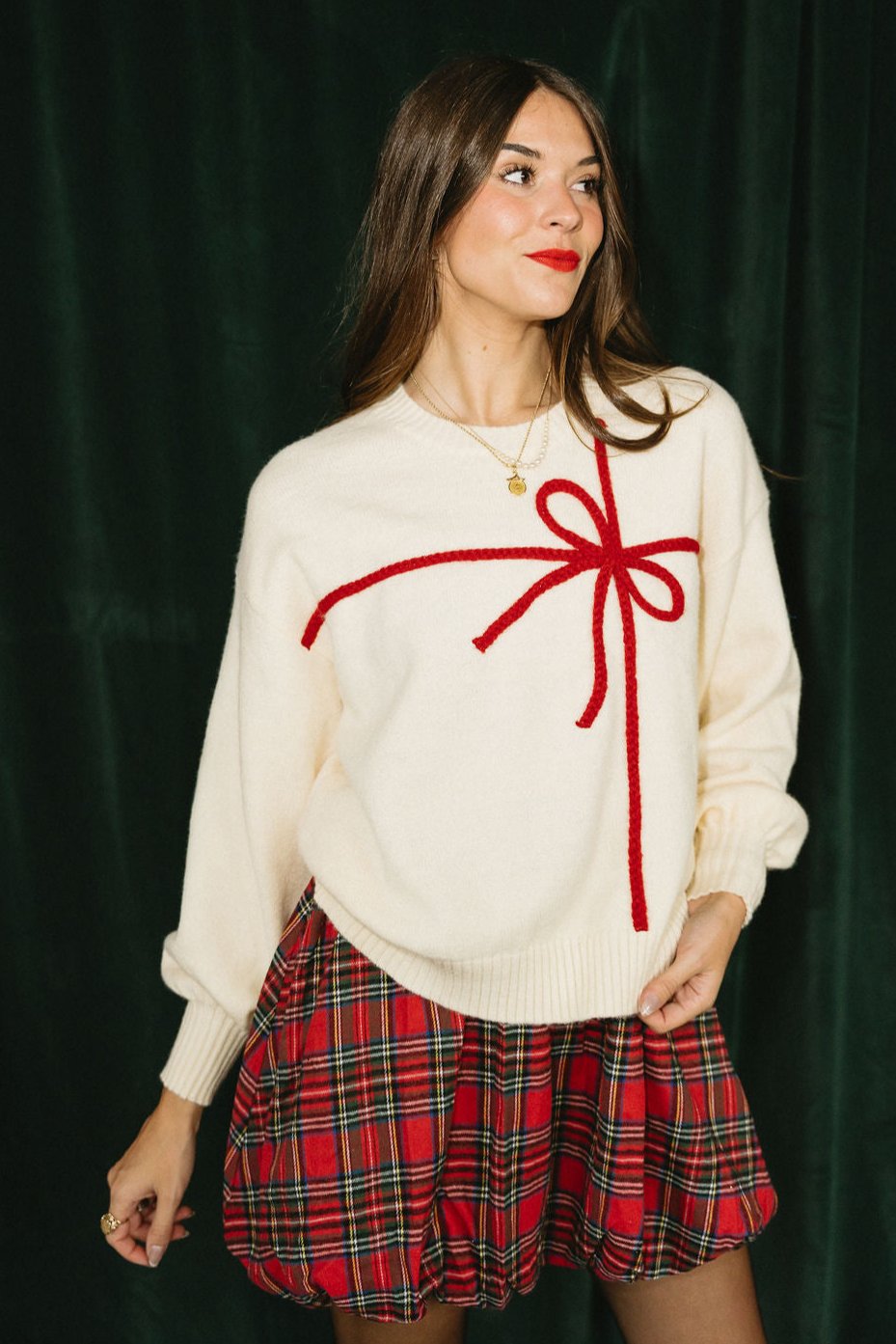 Chrissy Cream & Red Gift Bow Sweater- frontal side view