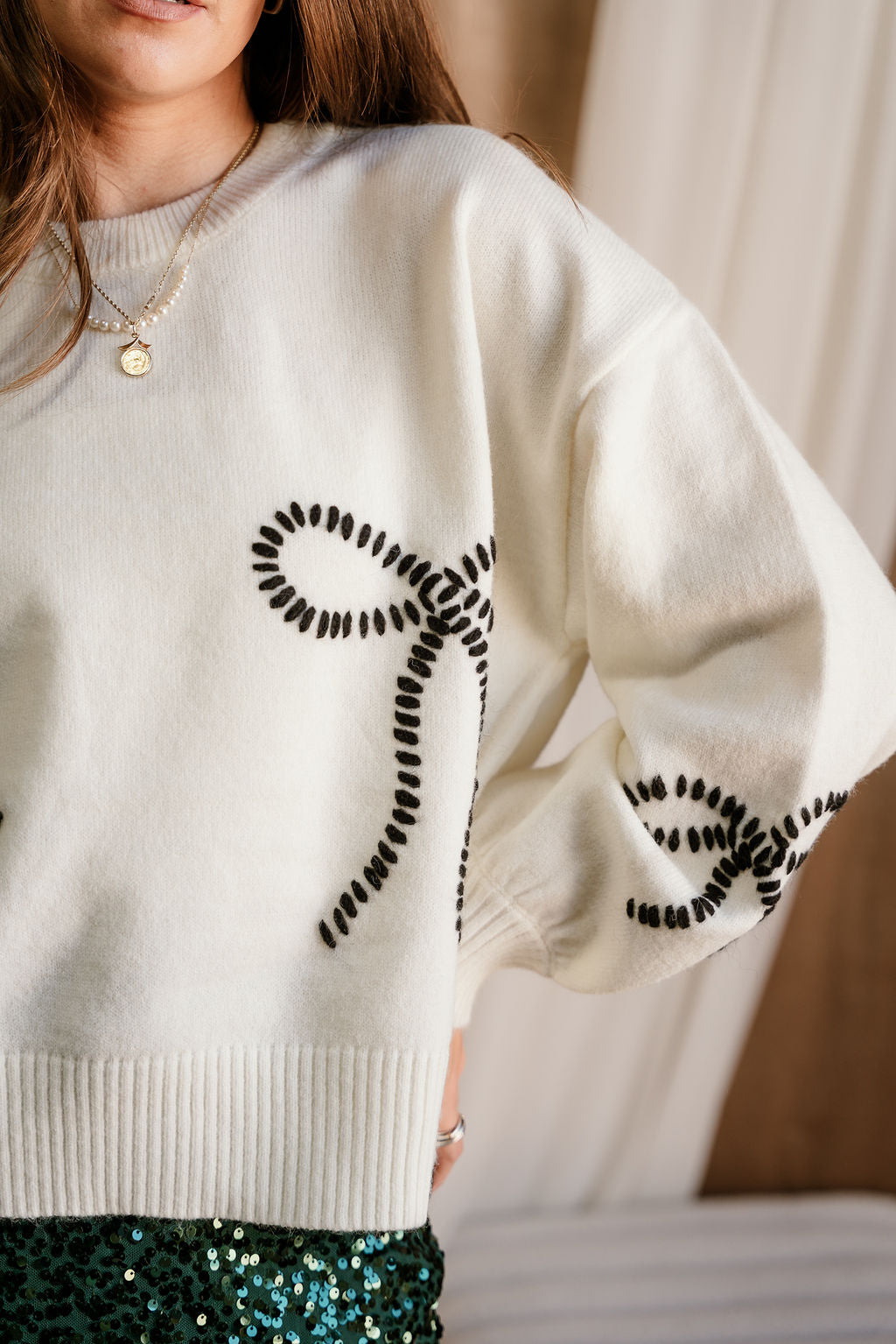 Grace Cream & Black Stitch Bows Sweater- close up left side view