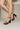 Melissa Black Patent Leather Block Heel- close up side view on model