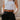 Front view of model wearing the Tiffany Black Shorts which features black fabric with black lining, a front zipper with hook closures, side pockets, faux back pocket details, belt loops, and front pleats.