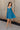 Full body view of model wearing the Lucille Dark Turquoise Sleeveless Mini Dress which features dark turquoise fabric, a smocked sweatheart neckline and back, smocked thick straps, and dark turquoise lining.