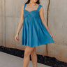 Full body view of model wearing the Lucille Dark Turquoise Sleeveless Mini Dress which features dark turquoise fabric, a smocked sweatheart neckline and back, smocked thick straps, and dark turquoise lining.